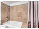 Bathtub with tiled shower and decorative curtain at 1108 E Georgia Ave, Phoenix, AZ 85014