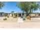 Charming single-story home with desert landscaping, solar panels, and a welcoming walkway at 1108 E Georgia Ave, Phoenix, AZ 85014