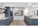 Updated kitchen showcasing blue cabinets, modern appliances, and sleek countertops at 1108 E Georgia Ave, Phoenix, AZ 85014
