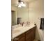 Bathroom with a double sink vanity, large mirror, and neutral color palette at 11867 W Alvarado Rd, Avondale, AZ 85392