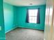 A brightly painted bedroom features neutral carpet, a window, and modern finishes at 11867 W Alvarado Rd, Avondale, AZ 85392