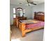 Bedroom with neutral carpet, complete with wooden furnishings, and a ceiling fan at 11867 W Alvarado Rd, Avondale, AZ 85392