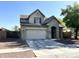 Charming two-story home featuring a neutral color palette, two car garage and mature landscaping at 11867 W Alvarado Rd, Avondale, AZ 85392