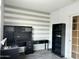 Cozy home office with striped accent wall, built in desk and storage cabinets at 11867 W Alvarado Rd, Avondale, AZ 85392