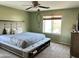 The main bedroom offers a calming space with a ceiling fan and lots of natural light at 11867 W Alvarado Rd, Avondale, AZ 85392
