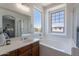 Bright bathroom features a soaking tub, shower, and large window overlooking the neighborhood at 1187 E Frances Ln, Gilbert, AZ 85295
