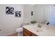Cozy bathroom features a traditional toilet, sink with vanity and a clean white color scheme at 1187 E Frances Ln, Gilbert, AZ 85295