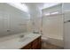 Bathroom with wood vanity, large mirror, tub with shower, and tile flooring at 1187 E Frances Ln, Gilbert, AZ 85295