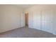 Bedroom with carpet flooring and a closet with white sliding doors at 1187 E Frances Ln, Gilbert, AZ 85295