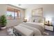 Comfortable bedroom with neutral tones, soft carpet, and a bright window bringing in natural light at 1187 E Frances Ln, Gilbert, AZ 85295