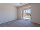 Bedroom with carpet, neutral paint, and sliding glass door to backyard at 1187 E Frances Ln, Gilbert, AZ 85295