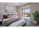 Serene bedroom featuring a sliding glass door to the backyard and a large framed picture at 1187 E Frances Ln, Gilbert, AZ 85295