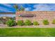The Spectrum at Val Vista community entrance with a stone wall, lush green lawn and desert landscaping at 1187 E Frances Ln, Gilbert, AZ 85295