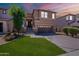 Charming two-story home featuring a well-maintained lawn, mature tree, and inviting front porch at 1187 E Frances Ln, Gilbert, AZ 85295