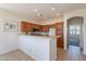 Well-lit kitchen showcasing wood cabinetry, modern appliances, and a convenient breakfast bar for casual dining at 1187 E Frances Ln, Gilbert, AZ 85295