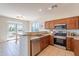 Well-equipped kitchen featuring stainless steel appliances, wood cabinets, breakfast bar and adjacent breakfast nook at 1187 E Frances Ln, Gilbert, AZ 85295