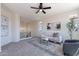 Upstairs living room area with plush carpet, a ceiling fan, and cozy seating with neutral decor at 1187 E Frances Ln, Gilbert, AZ 85295