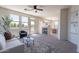 Inviting living room featuring a fireplace, large windows, and neutral decor with an adjacent dining area at 1187 E Frances Ln, Gilbert, AZ 85295