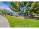 Well-maintained tennis court surrounded by mature trees and greenery in a park at 1187 E Frances Ln, Gilbert, AZ 85295