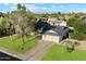 Overhead shot of a home with a well-kept lawn, mature trees, and a two-car garage at 13411 N 50Th St, Scottsdale, AZ 85254