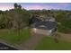 Aerial view of a home with a lush green lawn, mountain views, and a two-car garage at 13411 N 50Th St, Scottsdale, AZ 85254