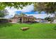 Lush backyard featuring a covered patio, green lawn, and potential for outdoor activities and relaxation at 13411 N 50Th St, Scottsdale, AZ 85254