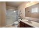 Bathroom featuring a glass shower, toilet, vanity with sink and a large mirror providing plenty of natural light at 13411 N 50Th St, Scottsdale, AZ 85254