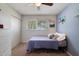 Bedroom with white walls, blue accent wall, neutral carpet, window and ceiling fan creating a comfortable atmosphere at 13411 N 50Th St, Scottsdale, AZ 85254