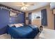 Bedroom featuring blue accent wall, window with natural light, and blue bedding creating a unique space at 13411 N 50Th St, Scottsdale, AZ 85254