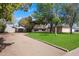 Expansive front yard leading to a charming home with mature trees and well-kept landscaping at 13411 N 50Th St, Scottsdale, AZ 85254