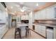Spacious kitchen features white cabinetry, center island, and modern appliances for culinary enthusiasts at 13411 N 50Th St, Scottsdale, AZ 85254