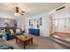 Cozy living room featuring a blue sofa, wooden coffee table, and decorative wall art at 13411 N 50Th St, Scottsdale, AZ 85254