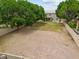Large backyard with scattered trees and partial landscaping, providing ample space for outdoor activities at 1377 W Park Ave, Gilbert, AZ 85233