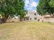 Lush backyard featuring a well-maintained lawn and mature trees, complemented by the home's exterior facade at 1377 W Park Ave, Gilbert, AZ 85233