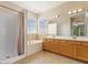 This bathroom features tile floors, a shower and tub, and a large vanity with double sinks at 1377 W Park Ave, Gilbert, AZ 85233
