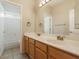 Well-lit bathroom featuring a spacious vanity, tiled floors, and a separate shower and toilet area at 1377 W Park Ave, Gilbert, AZ 85233