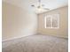 This room features neutral decor, carpet, a ceiling fan, and a window for natural light at 1377 W Park Ave, Gilbert, AZ 85233