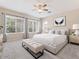 Bright bedroom featuring neutral decor, a ceiling fan, and large windows for plenty of natural light at 1377 W Park Ave, Gilbert, AZ 85233