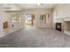 Bright living room featuring a fireplace and access to the backyard at 1377 W Park Ave, Gilbert, AZ 85233