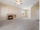 Open-concept living room with fireplace, light-colored walls, and plush carpeting at 1377 W Park Ave, Gilbert, AZ 85233