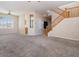 Bright, carpeted living room with ceiling fan and stairway at 1377 W Park Ave, Gilbert, AZ 85233
