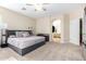 Spacious primary bedroom with neutral carpet, ceiling fan, and an attached bathroom at 1377 W Park Ave, Gilbert, AZ 85233