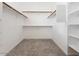 Organized walk-in closet with carpet, built-in shelving, and hanging rods for ample storage at 1377 W Park Ave, Gilbert, AZ 85233