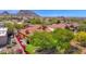 Beautiful aerial view of property with red tile roof, lush green backyard, and serene mountain views at 13914 E Laurel Ln, Scottsdale, AZ 85259