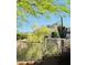 Backyard view featuring desert landscaping and a tall, mature Saguaro cactus, framed by mountain scenery at 13914 E Laurel Ln, Scottsdale, AZ 85259