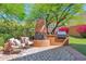 Outdoor living space featuring a custom fireplace, built-in grill, and comfortable seating area at 13914 E Laurel Ln, Scottsdale, AZ 85259