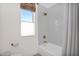 Bright bathroom with stylish gold shower fixtures and a tiled shower and tub combination at 13914 E Laurel Ln, Scottsdale, AZ 85259