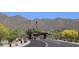 Gated community entrance with lush landscaping and American flag at 13914 E Laurel Ln, Scottsdale, AZ 85259