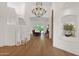 Grand foyer showcasing soaring ceilings, a stunning chandelier, staircase, and hardwood floors at 13914 E Laurel Ln, Scottsdale, AZ 85259