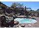 Relaxing hot tub with rock waterfall feature and beautiful desert landscaping at 13914 E Laurel Ln, Scottsdale, AZ 85259